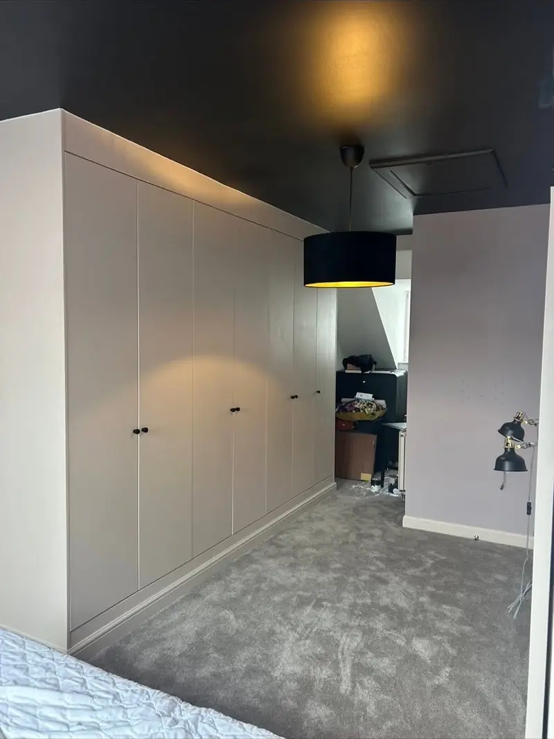 Fitted bedroom wardrobes painted to match a dark feature ceiling