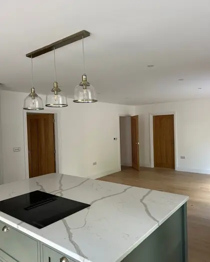 Kitchen island and units painted in soft sage green
