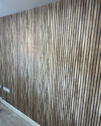 Textured vertical grain wall covering hung across a full wall